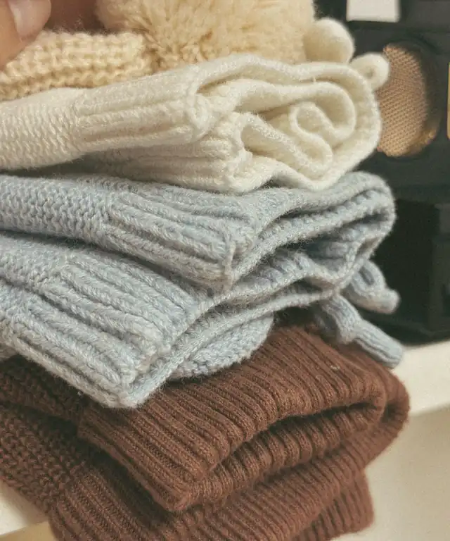Stacked knitwear in cream, blue and brown